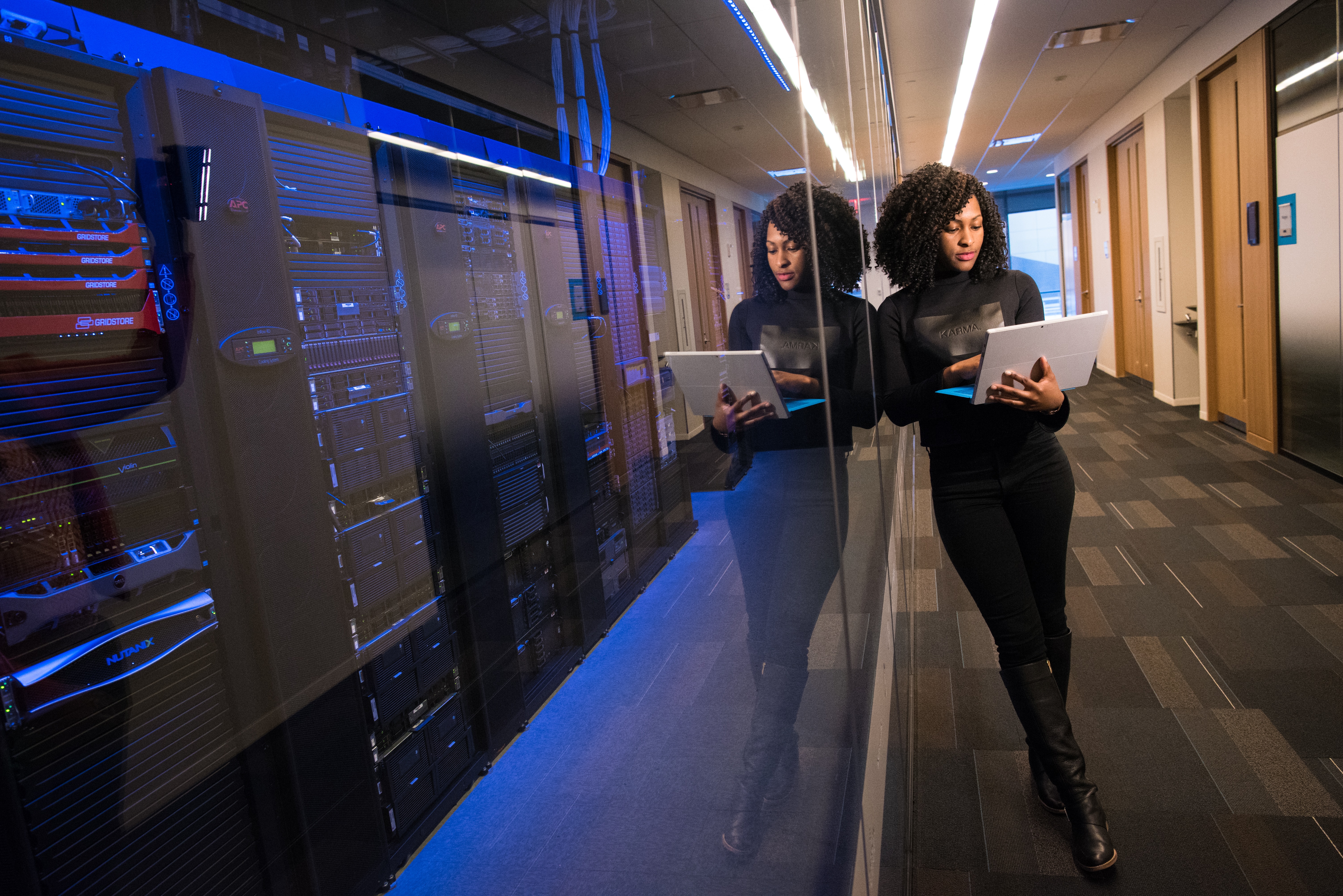 Women viewing laptop in front of serverbanks