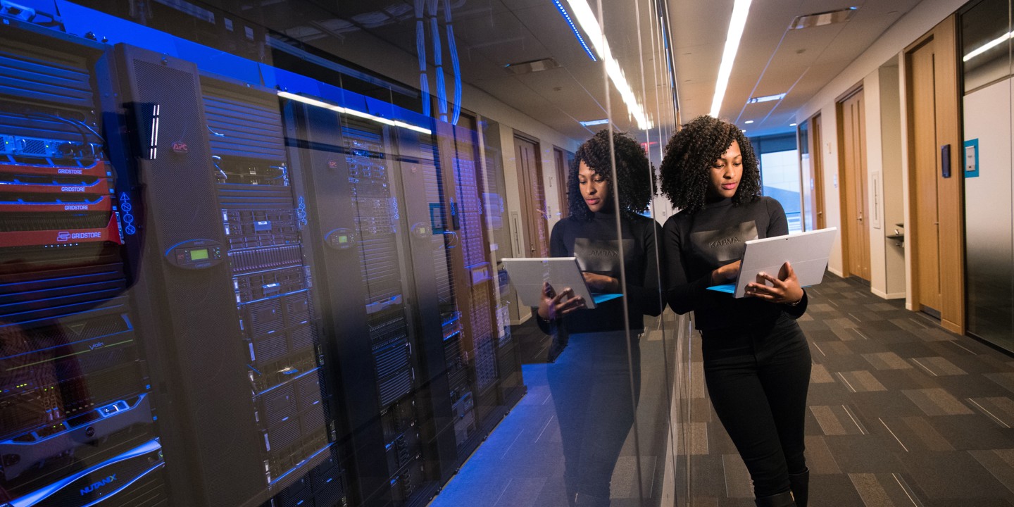 Women viewing laptop in front of serverbanks