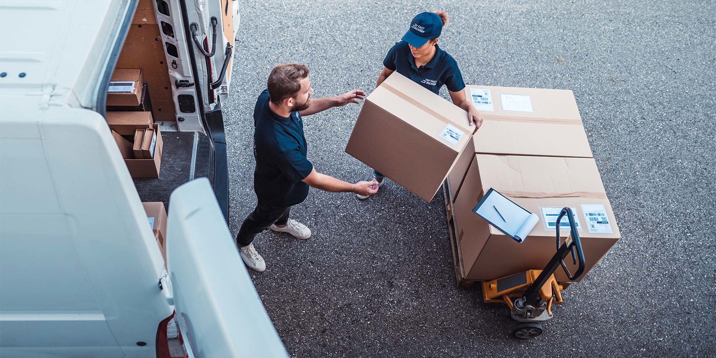 Woman handing box to man
